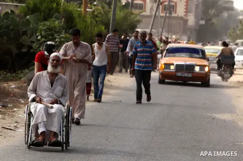 Palestinian families leave their neighborhood to a safer location as Israel's army continues shelling the area of Khan Yunis, in the southern Gaza Strip, on July 24, 2014. Seven Palestinians were killed in a series of st...