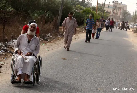 Palestinian families leave their neighborhood to a safer location as Israel's army continues shelling the area of Khan Yunis, in the southern Gaza Strip, on July 24, 2014. Seven Palestinians were killed in a series of st...