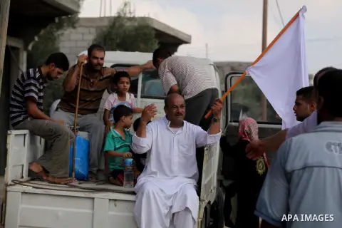 Palestinian families leave their neighborhood to a safer location as Israel's army continues shelling the area of Khan Yunis, in the southern Gaza Strip, on July 24, 2014. Seven Palestinians were killed in a series of st...