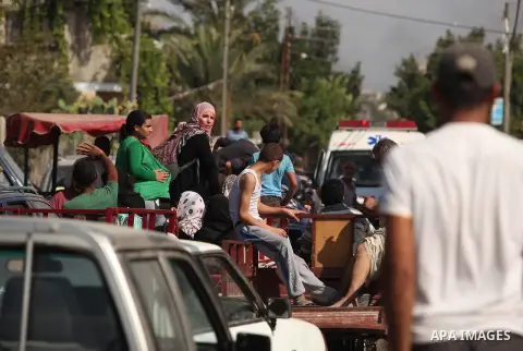 Palestinian families leave their neighborhood to a safer location as Israel's army continues shelling the area of Khan Yunis, in the southern Gaza Strip, on July 24, 2014. Seven Palestinians were killed in a series of st...