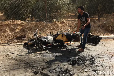 Palestinians inspect the remains of motorcycle that was hit by an Israeli air strike in Khan Yunis, in the southern Gaza Strip, on July 24, 2014. Seven Palestinians were killed in a series of strikes today in a flashpoin...