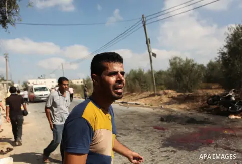 Palestinians inspect the remains of motorcycle that was hit by an Israeli air strike in Khan Yunis, in the southern Gaza Strip, on July 24, 2014. Seven Palestinians were killed in a series of strikes today in a flashpoin...