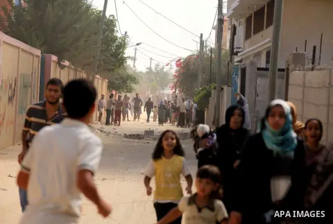 Palestinian families leave their neighborhood to a safer location as Israel's army continues shelling the area of Khan Yunis, in the southern Gaza Strip, on July 24, 2014. Seven Palestinians were killed in a series of st...