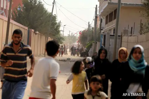 Palestinian families leave their neighborhood to a safer location as Israel's army continues shelling the area of Khan Yunis, in the southern Gaza Strip, on July 24, 2014. Seven Palestinians were killed in a series of st...