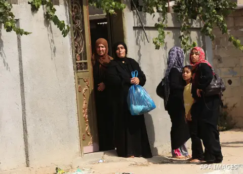 Palestinian families leave their neighborhood to a safer location as Israel's army continues shelling the area of Khan Yunis, in the southern Gaza Strip, on July 24, 2014. Seven Palestinians were killed in a series of st...