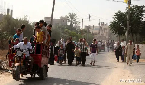 Palestinian families leave their neighborhood to a safer location as Israel's army continues shelling the area of Khan Yunis, in the southern Gaza Strip, on July 24, 2014. Seven Palestinians were killed in a series of st...