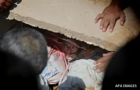 Palestinians bury the bodies of two Palestinian boys Abdulrahamn Abed al-Nabi, 1, and Hadi Abed al-Nabi, 3, who medics said were killed in an Israeli air strike, during their funeral at a cemetery in the northern Gaza St...