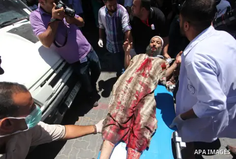 Palestinian man, who medics said was wounded by an Israeli air strike, arrives to a hospital in Khan Younis in the southern Gaza Strip July 24, 2014. Israel won a partial reprieve from the economic pain of its Gaza war o...