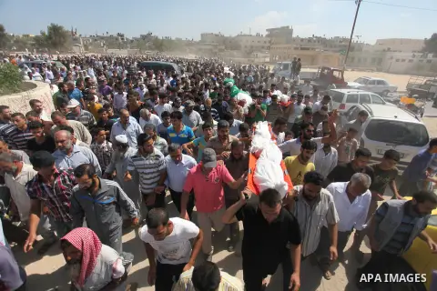 Palestinians carry the bodies of 11 member of al-Astal family, who were killed in an Israeli air strike, during their funeral in Khan Younis in the southern Gaza Strip, July 24, 2014. Hamas rejected a ceasefire the previ...