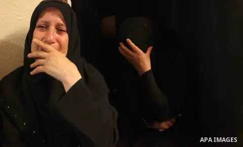 Relatives of four Palestinian brothers from Abu Shaqra family, whom medics said were killed by an Israeli air strike, mourn during their funeral in Khan Younis in the southern Gaza Strip July 24, 2014. Israel won a parti...
