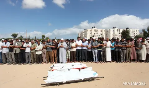 Palestinians perform funeral prayer for Palestinian Al Astal family members, died after an Israeli aircraft hit their house, in Khan Yunis in the southern Gaza Strip, Palestine on July 25, 2014. An Israeli defense offici...