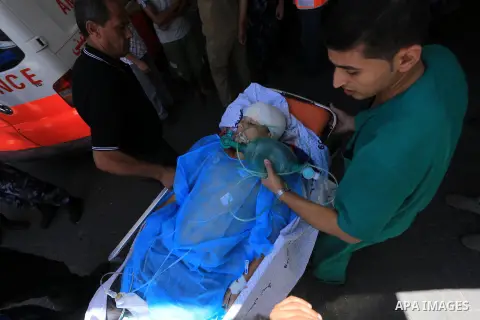 A Palestinian man, wounded following an Israeli air strike, receives treatment at al-Shifa hospital in Gaza City on July 25, 2014. An Israeli defense official says the Israeli Security Cabinet is meeting to discuss inter...