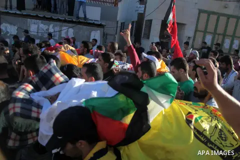 Mourners carry the bodies of three Palestinians, who medics said were killed during clashes with Israeli troops, during their funeral in Beit Ommar town north of West Bank city of Hebron July 25, 2014. Five Palestinians...