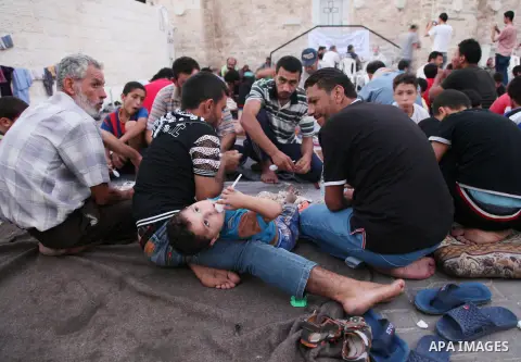 Displaced Palestinian gather of Iftar meal at a Greek Orthodox church where many Palestinians are taking shelter in Gaza City on July 25, 2014. US Secretary of State John Kerry entered new meetings with UN chief Ban Ki-m...
