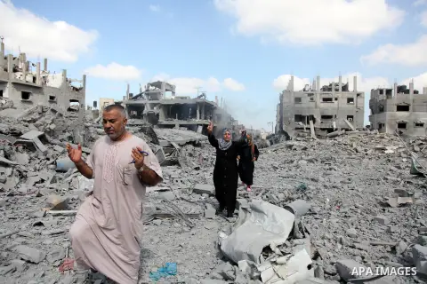 Palestinians walk on the rubble as they enter the northern district of Beit Hanun to check their homes in the Gaza Strip during an humanitarian truce on July 26, 2014. Palestinians retrieved dozens of bodies from the rub...