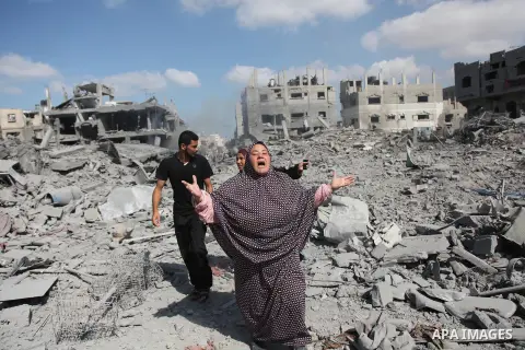 A Palestinian woman reacts at seeing destroyed homes in the northern district of Beit Hanun in the Gaza Strip during an humanitarian truce on July 26, 2014. Palestinians retrieved dozens of bodies from the rubble of Gaza...