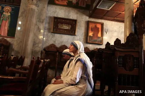 Nuns react during the funeral of Palestinian Christian woman Jalila Faraj Ayyad, whom medics said was killed in an Israeli air strike, at the Saint Porfirios church in Gaza City July 27, 2014. Palestinian medics said at...