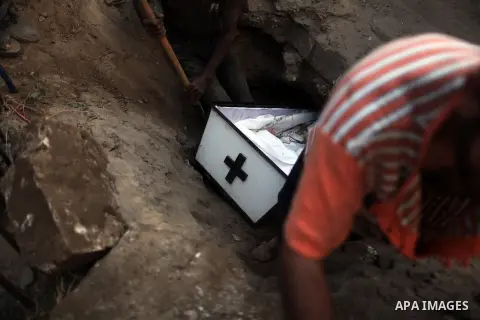Relatives bury the body of Palestinian Christian woman Jalila Faraj Ayyad, whom medics said was killed in an Israeli air strike, in Gaza City July 27, 2014. Palestinian medics said at least 10 people had died in the wave...