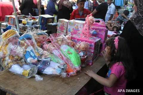 Palestinians shop for preparation for the upcoming Eid al-Fitr festival, at a market in the West Bank City of Ramallah on July 27, 2014. Eid al-Fitr festival is welcomed as a sad Eid between Palestinians as Israeli force...