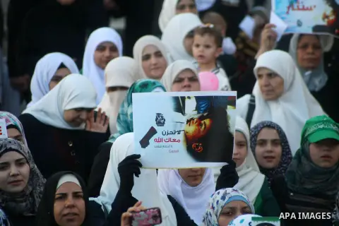 Female supporters of Hamas movement take part in a protest against the Israeli military operation in Gaza Strip as they celebrating the Eid al-Fitr festival, marking the end of the holy month of Ramadan, in the West Bank...
