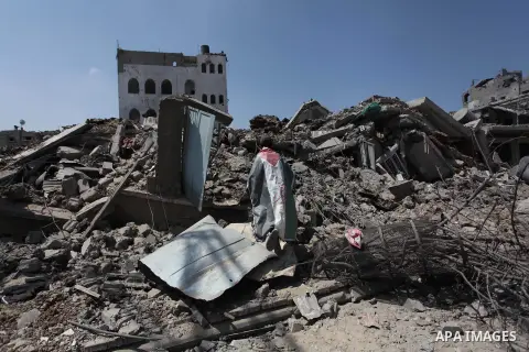 A Palestinian man reacts as he looks at the rubble of destroyed buildings and homes in the Shejaiya residential district of Gaza City on July 28, 2014. on the beginning of the Muslim Eid festival ending the month-long fa...
