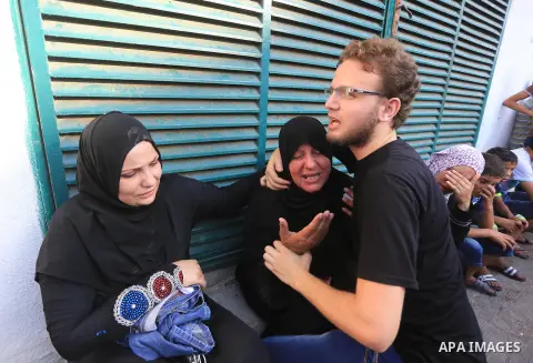 Palestinian mourners cry at Gaza City's al-Shifa hospital after an explosion killed at least seven children in a public playground in the beachfront Shati refugee camp on July 28, 2014. At least 10 Palestinians are kille...