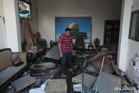 A Palestinian man inspects the rubble of the house of Hamas top leader in Gaza, Ismail Haniya, after it was hit by an overnight Israeli air strike, on July 29, 2014 in Gaza City. Bloodshed in and around Gaza surged with...