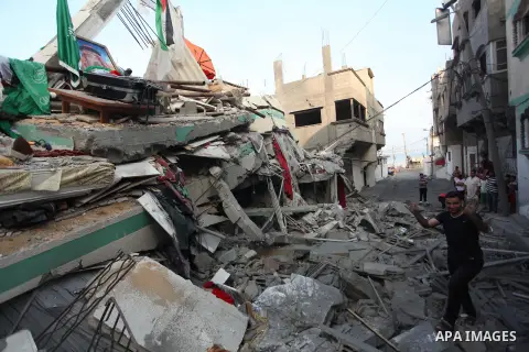 A Palestinian man inspects the rubble of the house of Hamas top leader in Gaza, Ismail Haniya, after it was hit by an overnight Israeli air strike, on July 29, 2014 in Gaza City. Bloodshed in and around Gaza surged with...