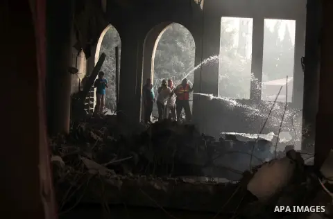 Palestinian firefighters extinguish fire at a mosque after it was hit by an Israeli air strike, on July 29, 2014, in Gaza City. Bloodshed in and around Gaza surged with strikes killing at least 13 Palestinians, a day aft...