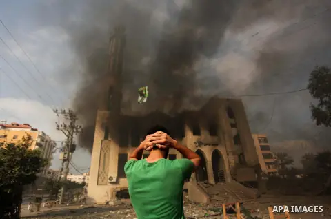A Palestinian man reacts in front of a destroyed mosque after it was hit by an Israeli air strike, on July 29, 2014, in Gaza City. Bloodshed in and around Gaza surged with strikes killing at least 13 Palestinians, a day...
