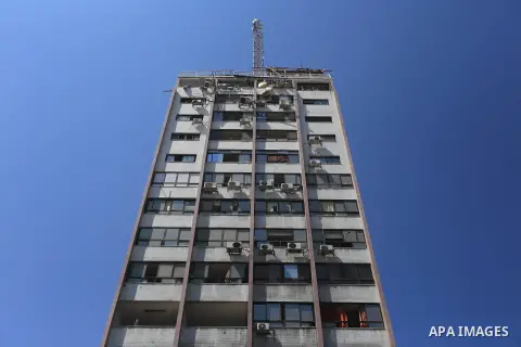 The top floors of Al Shorouk tower, housing media offices, can be seen damaged after they were hit by an overnight Israeli strike, in Gaza City, northern Gaza Strip, Tuesday, July 29, 2014. Early Tuesday, Israel warplane...