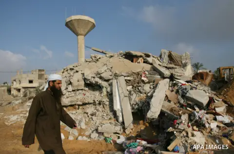 Palestinians search for victims as people gather atop the remains of a house, which witnesses said was destroyed in an Israeli air strike, in Rafah in the southern Gaza Strip July 29, 2014. Israel's military pounded targ...