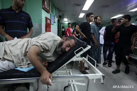 A Palestinian man, whom medics said was wounded in an Israeli air strike on a compound housing a UN school in Jabalia refugee camp in the northern Gaza Strip, receives treatment at the Kamal Edwin hospital in Beit Lahia...