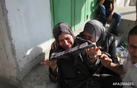 Palestinians who lost relatives in an Israeli strike on a compound housing a UN school in Jabalia refugee camp in the northern Gaza Strip, mourn outside the Kamal Edwin hospital in Beit Lahia where victims from the attac...