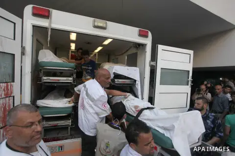 Palestinian medics wheel a wounded man, following an Israeli Strike in Shijaiyah neighborhood, to the emergency room of the Shifa Hospital, in Gaza City, Wednesday, July 30, 2014. Photo by Ashraf Amra