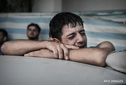 Palestinians cry after identifying their loved one, killed on an Israeli strike in Shijaiyah neighbourhood, at the morgue of Gaza City's Shifa hospital, Wednesday July 30, 2014. Israeli strikes hit the crowded shopping a...