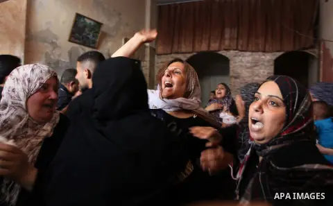 Palestinian relatives of Mohammed al-Daeri, 25, mourn during his funeral in Gaza City on July 31, 2014. At least 10 people were killed in Israeli strikes on central and southern Gaza bringing the Palestinian death toll t...