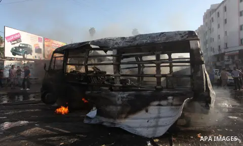 Palestinians inspect a destroyed bus after Israeli airstrikes in the central Gaza City, 31 July 2014. Two weeks after starting its ground offensive in the Gaza Strip, Israel has mobilized 16,000 more reserve troops. The...