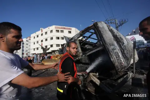 Palestinian firefighters try to extinguish the flames in a van, that was reportedly targeted by an Israeli military strike, in Gaza City on July 31, 2014. Israel said it would not pull troops from Gaza until they finish...