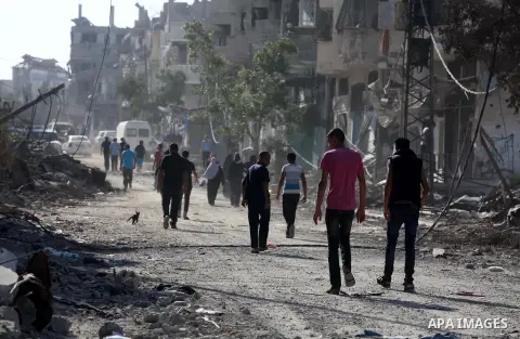 Palestinians who were displaced from their houses due fighting between Israel's army and Hamas fighters return to check their homes in Gaza City's Shejaiya neighbourhood, on August 1, 2014. Israeli shelling killed eight...