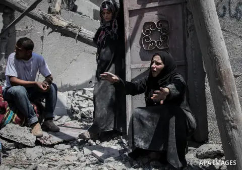 A Palestinian woman stands near the rubble of destroyed houses in the heavily bombed town of Beit Hanoun, Gaza Strip, close to the Israeli border, Friday, Aug. 1, 2014. A three-day Gaza cease-fire that began Friday quick...