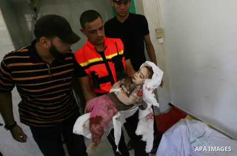 Palestinian relatives carry the body of one year old Rezeq Abu Taha, killed during attacks on the Gaza Strip, in Rafah, in the southern Gaza Strip on August 2, 2014. A fresh wave of violence killed dozens in Gaza after t...