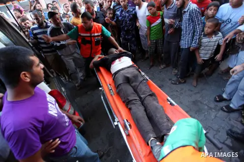 A Palestinian man, wounded following an Israeli military strike, is treated upon his arrival at the hospital in Khan Younis, in the southern Gaza Strip August 3, 2014. An Israeli air strike killed at least 10 people and...