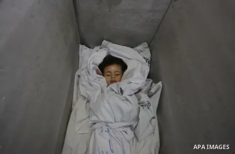 The body of two-and-a-half-year-old Palestinian girl Raghad Massoud, whom medics said was killed in an Israeli air strike, is seen inside an ice-cream freezer at Kuwaiti Hospital, which does not have a morgue, in Rafah i...