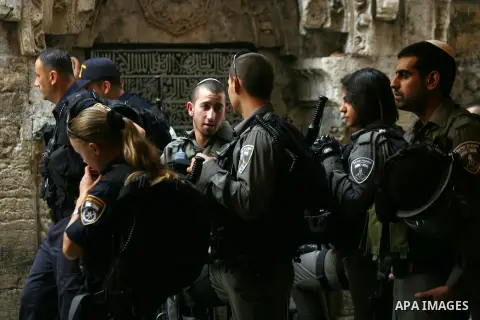 Israeli policemen prevent Palestinian worshippers from entering the Al-Aqsa mosque compound in the Old City of Jerusalem on August 4, 2014. Photo by Saeed Qaq
