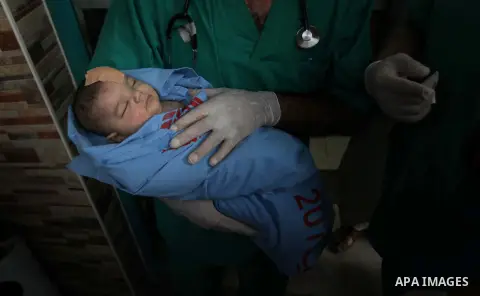 Palestinian medics treat an infant, whom medics said was wounded in an Israeli air strike, at a hospital in Rafah in the southern Gaza Strip August 4, 2014. A brief Israeli truce to allow aid to reach Palestinians ended...