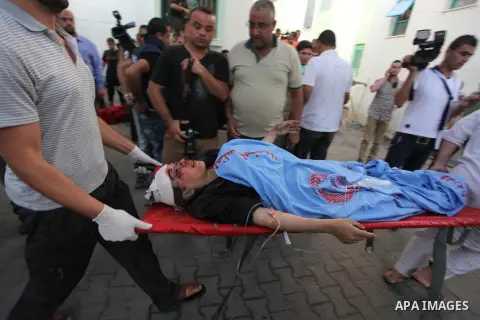 Palestinian medics treat a woman, whom medics said was wounded in an Israeli air strike, at a hospital in Rafah in the southern Gaza Strip August 4, 2014. A brief Israeli truce to allow aid to reach Palestinians ended on...