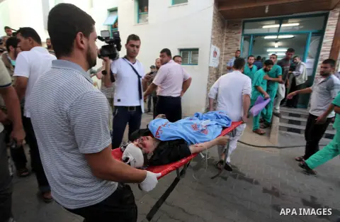 Palestinian medics treat a woman, whom medics said was wounded in an Israeli air strike, at a hospital in Rafah in the southern Gaza Strip August 4, 2014. A brief Israeli truce to allow aid to reach Palestinians ended on...