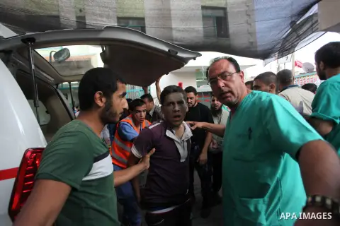 Palestinian medics treat a boy, whom medics said was wounded in an Israeli air strike, at a hospital in Rafah in the southern Gaza Strip August 4, 2014. A brief Israeli truce to allow aid to reach Palestinians ended on M...