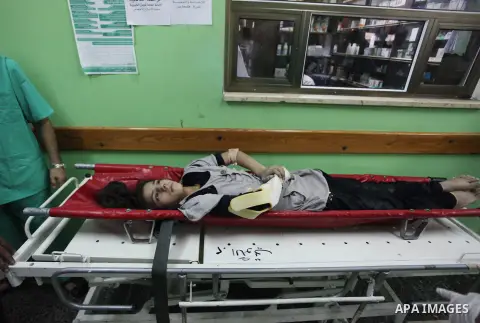 Palestinian medics treat a girl, whom medics said was wounded in an Israeli air strike, at a hospital in Rafah in the southern Gaza Strip August 4, 2014. A brief Israeli truce to allow aid to reach Palestinians ended on...